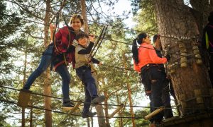 A family enjoys a thrilling day on a ropes course in Cercedilla, Spain.