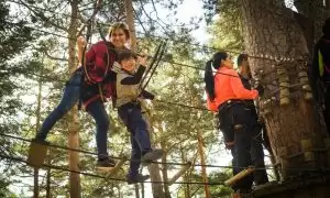A family enjoys a thrilling day on a ropes course in Cercedilla, Spain.